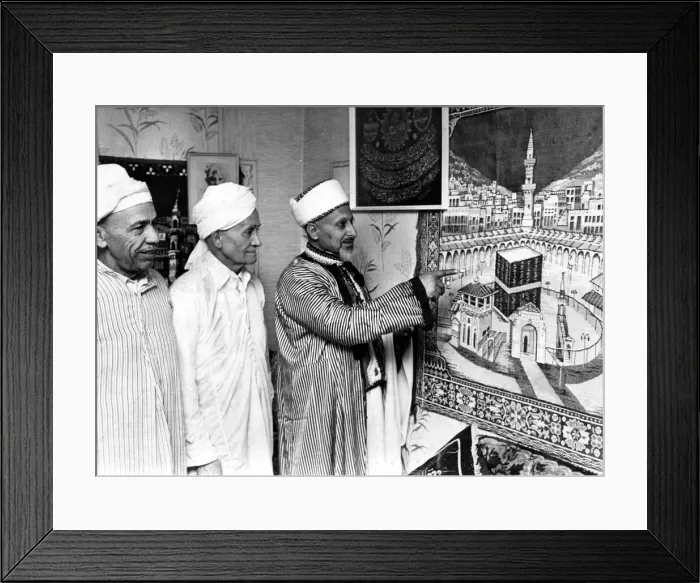 Framed Print : Mr Saleh Hassen of Loudon Square showing a tapestry of Kaaba Mecca to two members of Framed Print : Mr Saleh Hassen of Loudon Square showing a tapestry of Kaaba Mecca to two members of