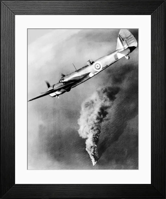 Framed Print : A Royal Air Force Bristol Beufighter aircraft flies over the burning hulk of a Framed Print : A Royal Air Force Bristol Beufighter aircraft flies over the burning hulk of a
