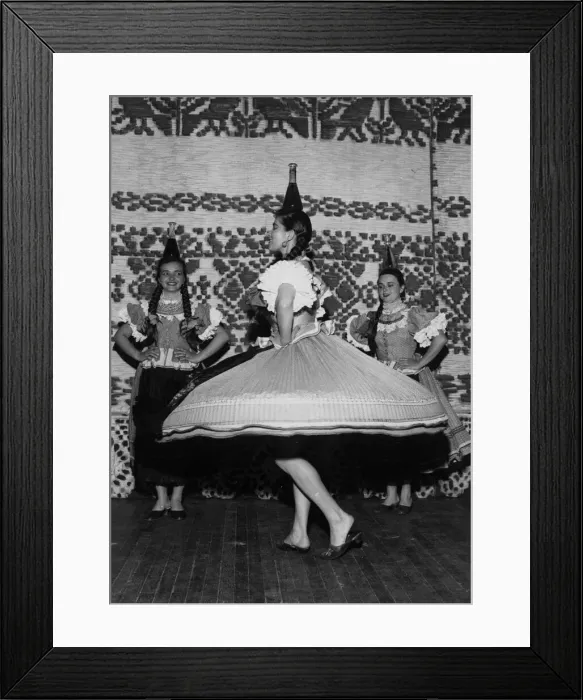 Framed Print : Dancer Elizabeth varga calmly balances a flagon of wine on her head as she dances a Framed Print : Dancer Elizabeth varga calmly balances a flagon of wine on her head as she dances a