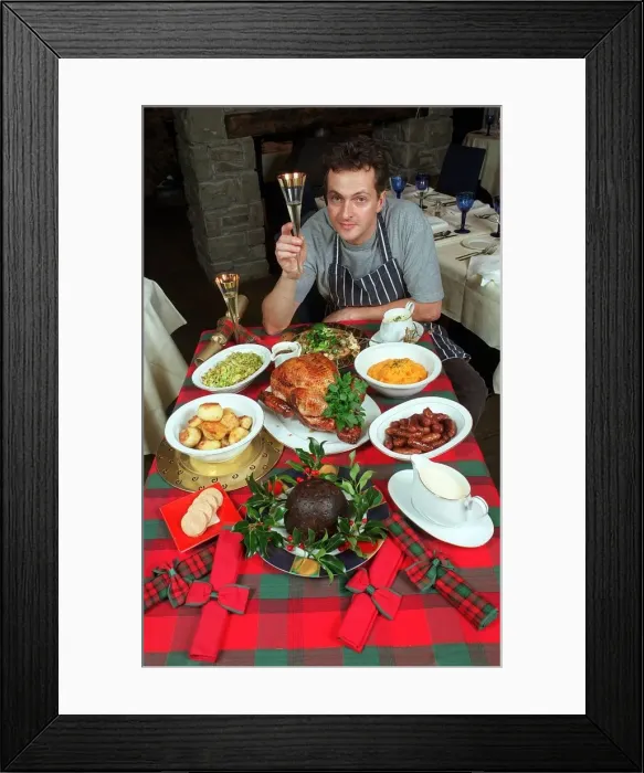 Framed Print : Nick Nairn television chef with Christmas Meal and a glass of wine circa 1998