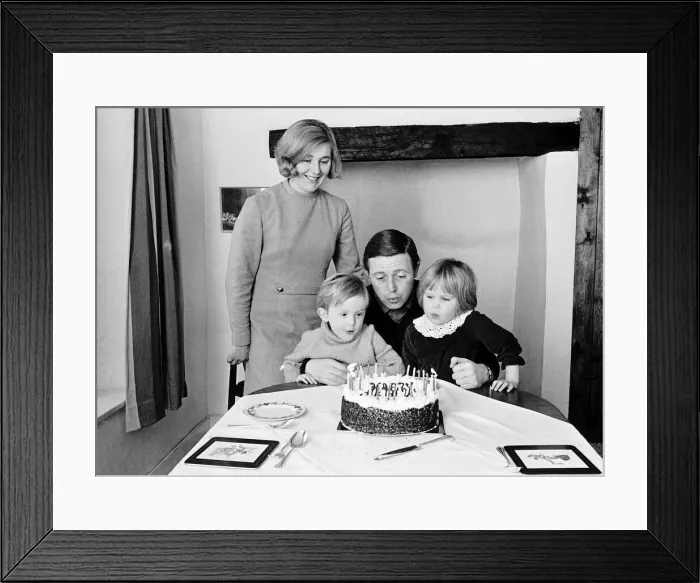 Framed Print : Michael Aspel tv presenter with his family blowing out birthday cake candles Framed Print : Michael Aspel tv presenter with his family blowing out birthday cake candles