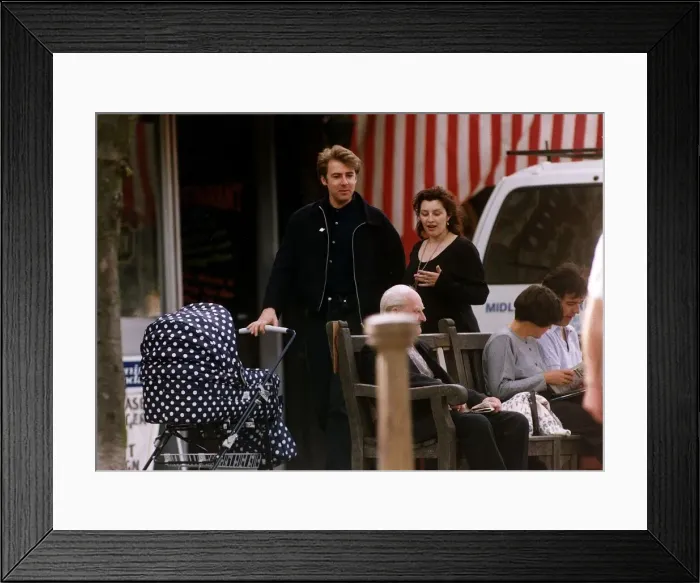 Framed Print : Jonathan Ross with wife jane walking down street pushing pram Framed Print : Jonathan Ross with wife jane walking down street pushing pram