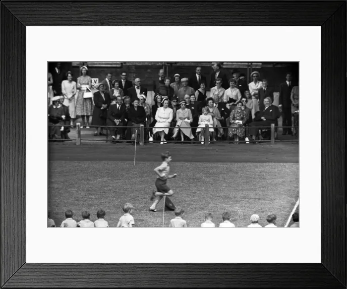 Framed Print : Prince Charles aged 9 at school sports day running, watched by Queen Elizabeth
