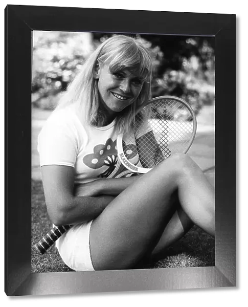 Sue Barker Tennis player sitting on grass holding tennis racket at Wimbledon