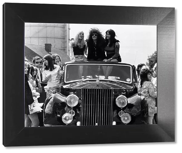 Marc Bolan pop singer rides roof of Rolls Royce 1972