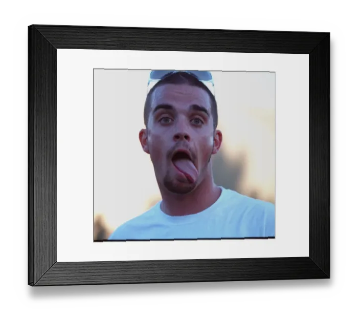 Framed Print : Robbie Williams sticking his tongue out to photographers at T in The Park festival Framed Print : Robbie Williams sticking his tongue out to photographers at T in The Park festival