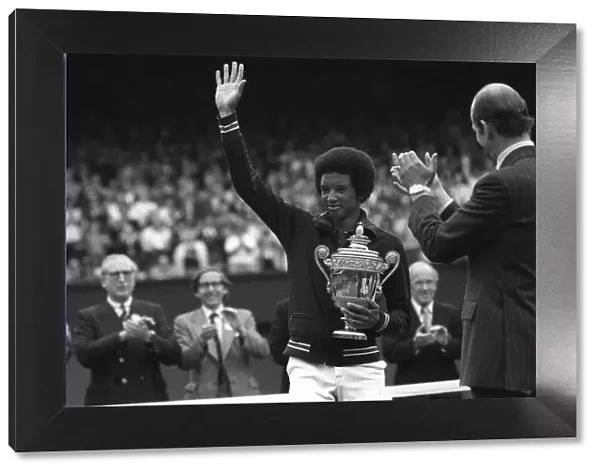 Arthur Ashe waves to fans after winning mens title in 1975 at Wimbledon with Duke of Kent