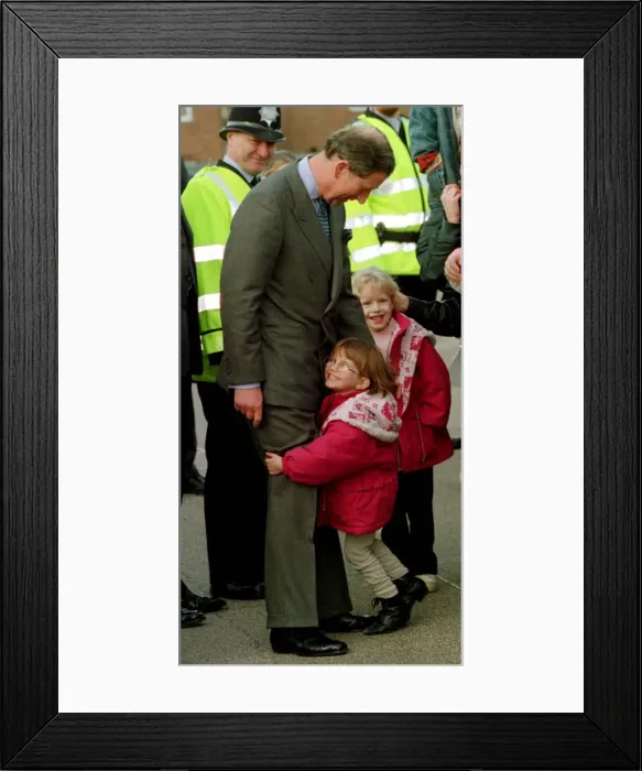 Framed Print : Prince Charles gets an unexpected hug from four year old Sarah Norris during a school Framed Print : Prince Charles gets an unexpected hug from four year old Sarah Norris during a school