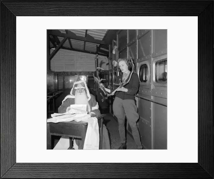 Framed Print : Father Christmas seen here at London Zoo with a pair of reindeer antlers