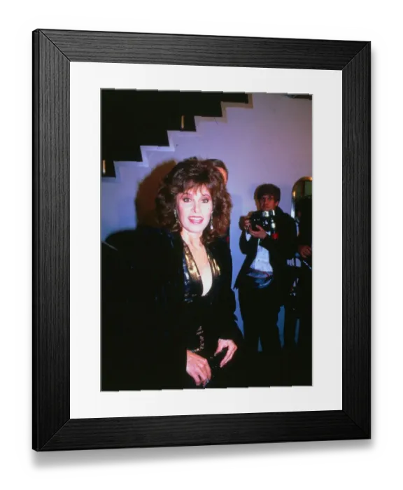 Framed Print : Actress Stephanie Powers February 1989 wearing low cut navy and gold dress