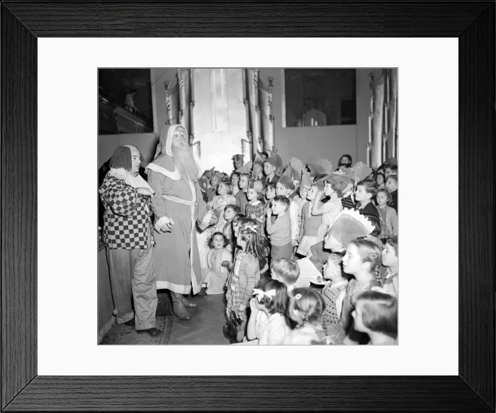 Framed Print : Father Christmas and his clown sidekick address the children at the yearly Daily Mirror Framed Print : Father Christmas and his clown sidekick address the children at the yearly Daily Mirror