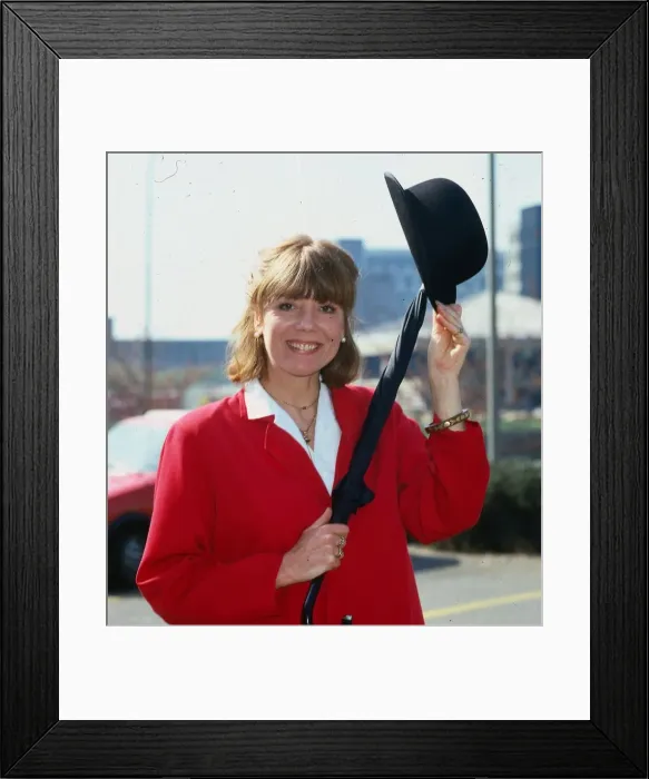 Framed Print : Diana Rigg actress April 1984 wearing red jacket holding bowler hat and umbrella Framed Print : Diana Rigg actress April 1984 wearing red jacket holding bowler hat and umbrella