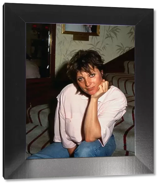 Suzanne Danielle August 1987 actress sitting on stairs hand at chin