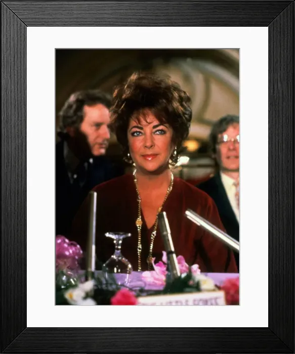Framed Print : Elizabeth Taylor sitting at table February 1982