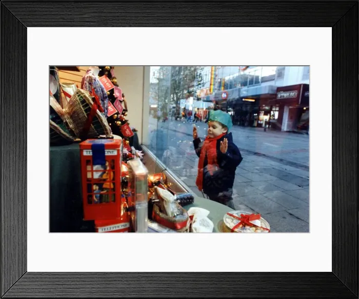 Framed Print : Christmas - A young child peers at the Christmas decorations Framed Print : Christmas - A young child peers at the Christmas decorations