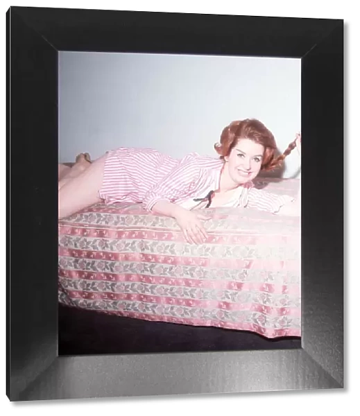 Heller Toren model actress 1964 lying on bed pink striped shirt