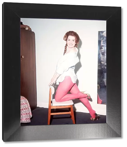 Heller Toren model actress 1964 knee on chair holding back pink tights white shirt