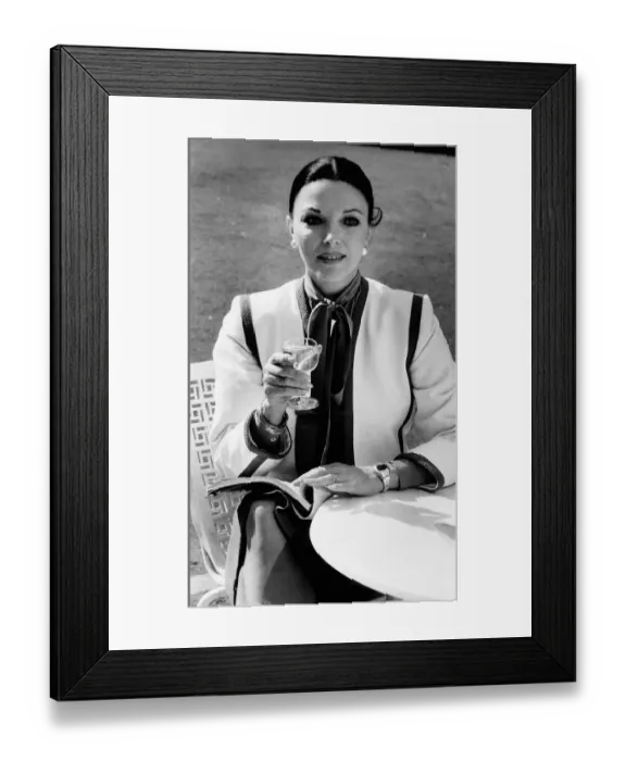 Framed Print : Joan Collins actress with her hair tied back and holding a wine glass Framed Print : Joan Collins actress with her hair tied back and holding a wine glass