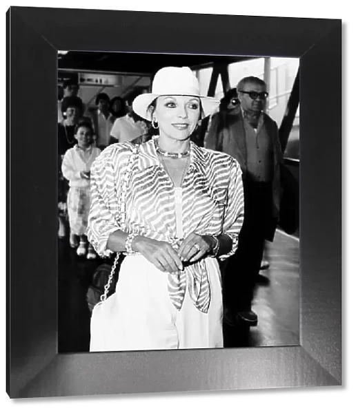 Joan Collins Actress arrives at Heathrow Airport from Nice France A©Mirrorpix