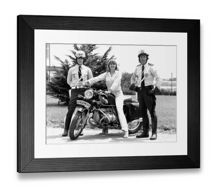 Framed Print : Susan Penhaligon, film actress July 1977 borrows a motorbike from two gendarmes during a Framed Print : Susan Penhaligon, film actress July 1977 borrows a motorbike from two gendarmes during a