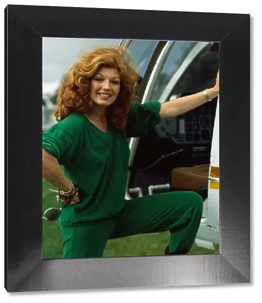 Rula Lenska sdtanding next to helicopter August 1985