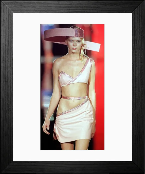 Framed Print : A model pink dress with cut outs and strange hat designed by Paco Rabanne for his 1999