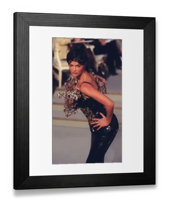 Framed Print : Helena Christensen poses in a black corset from Dior at a Paris Fashion Week in 1997