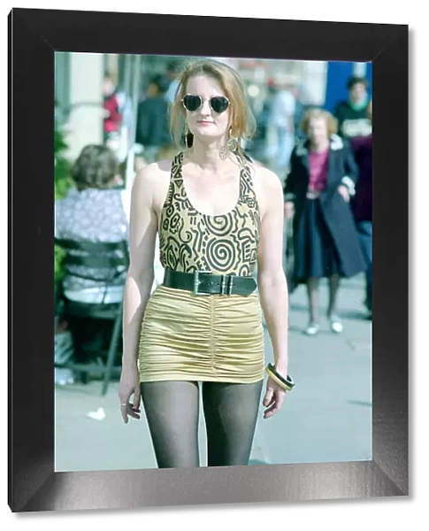 Fashion 1990s Woman walking down the street wearing a mini skirt with a leotard