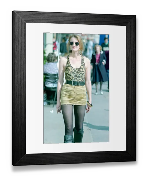 Framed Print : Fashion 1990s Woman walking down the street wearing a mini skirt with a leotard