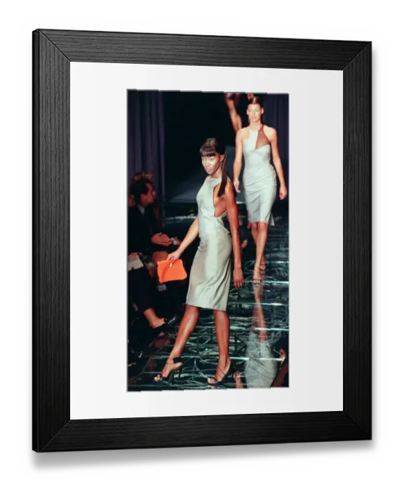 Framed Print : Naomi Campbell models one of the dresses from the first ever collection designed by