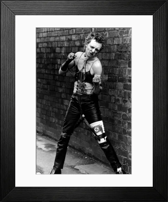 Framed Print : Punk rocker Dancing in the street by a wall wearing a vest top Framed Print : Punk rocker Dancing in the street by a wall wearing a vest top