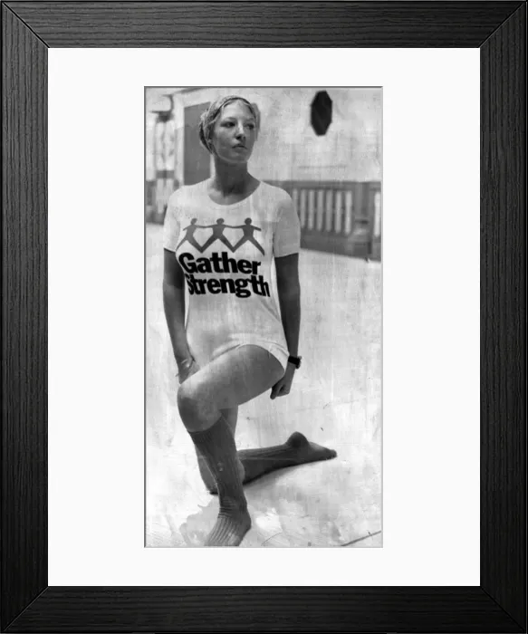 Framed Print : A girl wearing a t-shirt with the slogan Gather Strength'written across it Framed Print : A girl wearing a t-shirt with the slogan Gather Strength'written across it