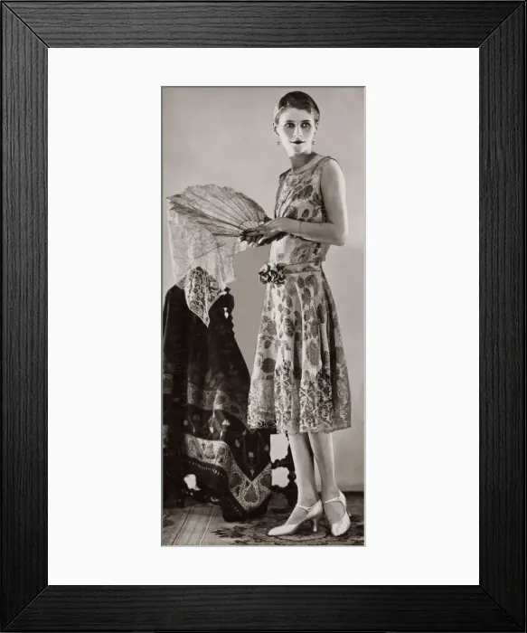 Framed Print : A woman wearing white and gold brocade evening gown which has a tight bodice Framed Print : A woman wearing white and gold brocade evening gown which has a tight bodice