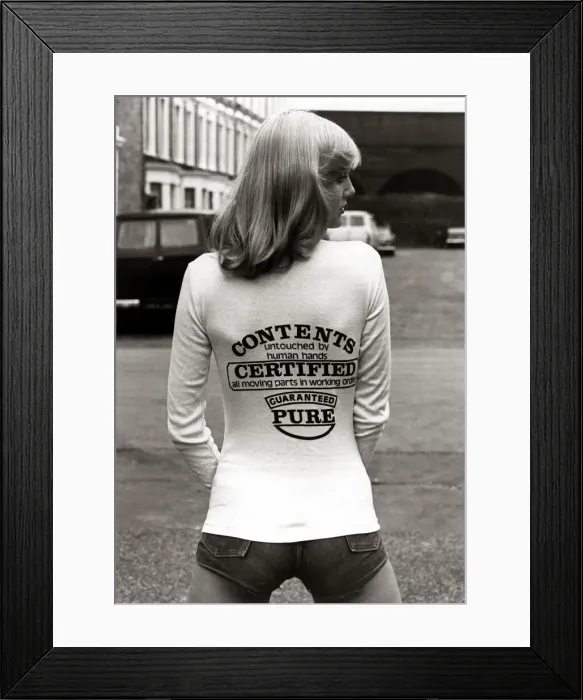 Framed Print : A model wearing a t-shirt with a joke message on the back August 1976 Framed Print : A model wearing a t-shirt with a joke message on the back August 1976