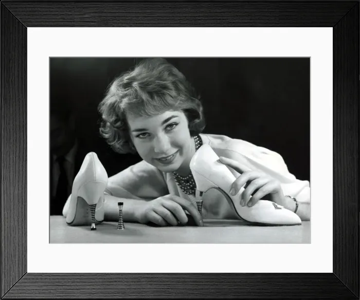Framed Print : A model showing off a pair of new high heel shoes, which have steel heels that screw Framed Print : A model showing off a pair of new high heel shoes, which have steel heels that screw