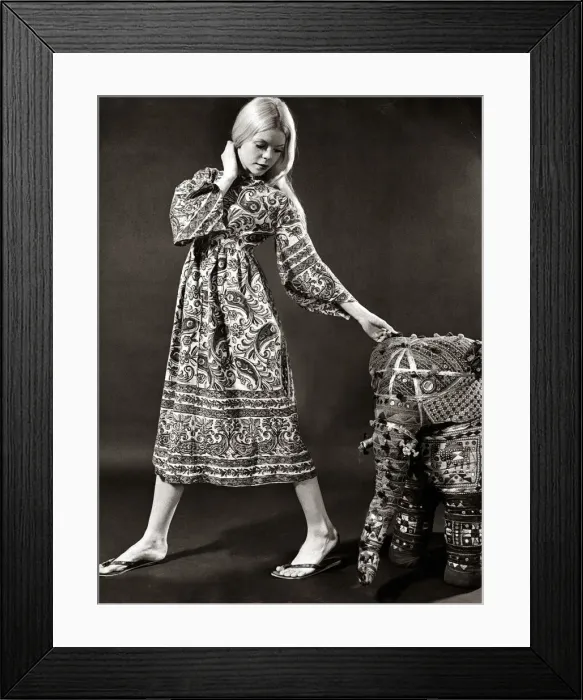 Framed Print : A model wearing a swirly print midi dress with wide bell sleeves made from Indian cotton