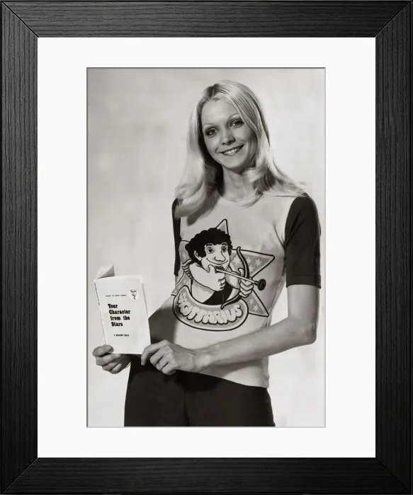Framed Print : Model wearing a zodiac sign t-shirt witha cartoon of Sagittarius on it holding a book