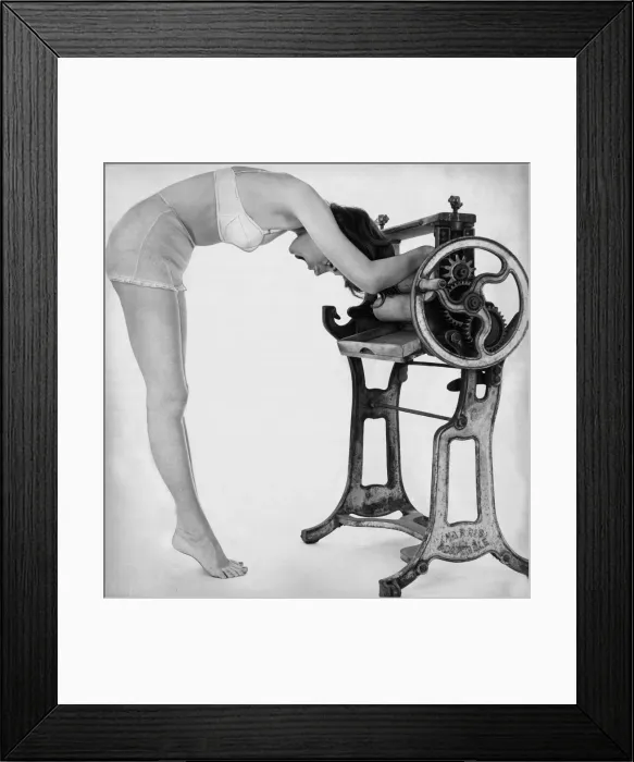 Framed Print : A woman wearing underwear drying her through an old fashioned roller machine Framed Print : A woman wearing underwear drying her through an old fashioned roller machine