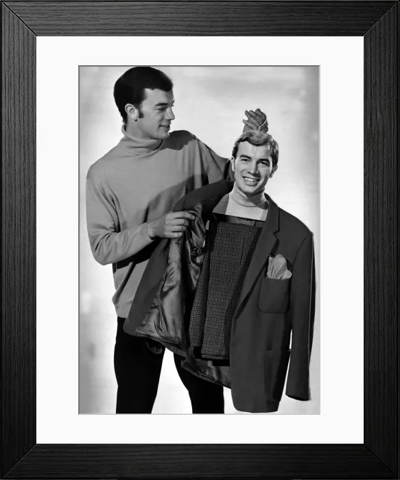Framed Print : A man hanging up his clothes on a hangar with a life sized image of his head Framed Print : A man hanging up his clothes on a hangar with a life sized image of his head