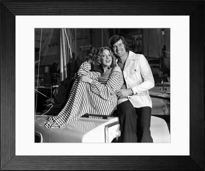 Framed Print : Man and woman posing together on a boat. he is wearing a washable safari jacket with Framed Print : Man and woman posing together on a boat. he is wearing a washable safari jacket with