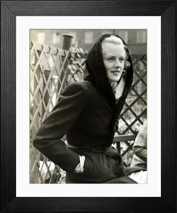 Framed Print : Fashion 1930s Model Waring a black wool coat with hood Framed Print : Fashion 1930s Model Waring a black wool coat with hood