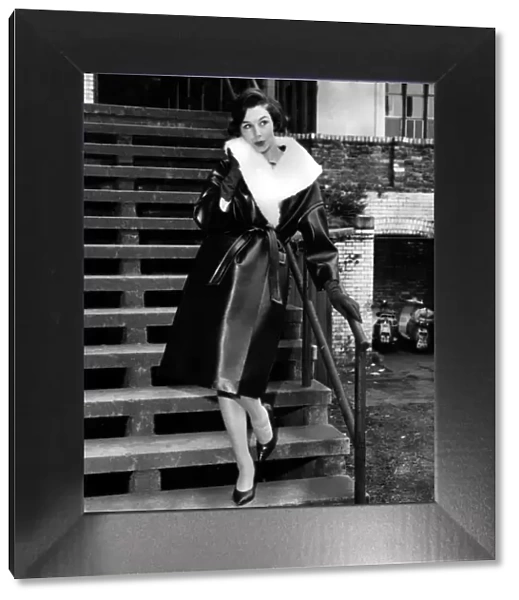 Model Stella Grove August 1960 in a leather look outfit lined with fur standing
