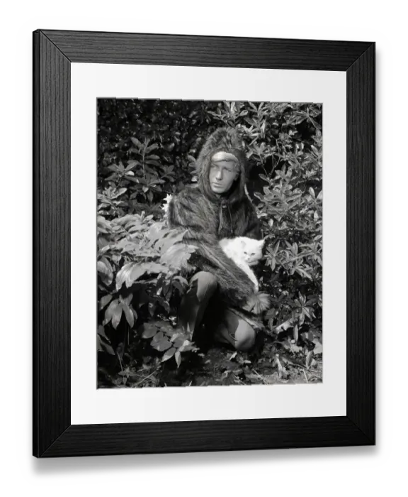 Framed Print : Ted Dawson modelling a fake fur coat with a hood for men while holding a white furry cat Framed Print : Ted Dawson modelling a fake fur coat with a hood for men while holding a white furry cat