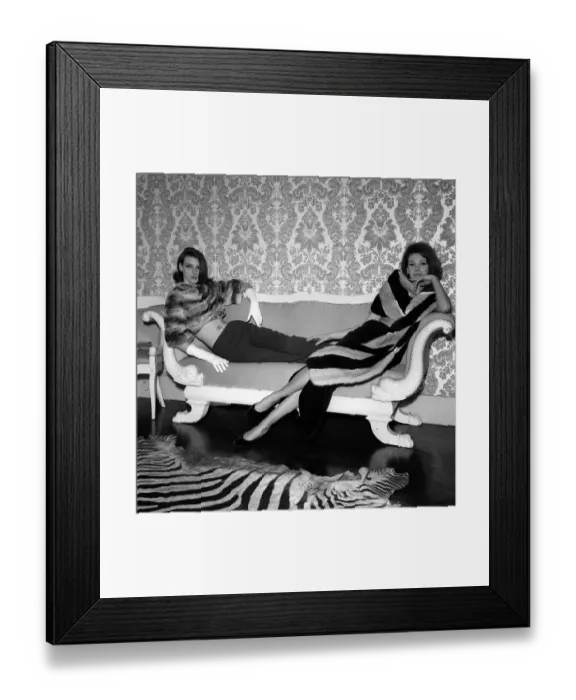Framed Print : 1960s Fashion Clothing December 1962 Models wearing Fur Coats reclining on a sofa Framed Print : 1960s Fashion Clothing December 1962 Models wearing Fur Coats reclining on a sofa
