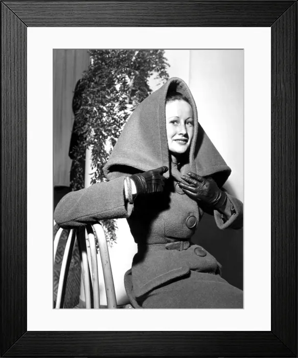 Framed Print : A woman wearing a woollen two piece fabric suit coat with a collar / hood Framed Print : A woman wearing a woollen two piece fabric suit coat with a collar / hood