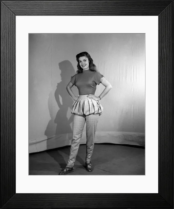 Framed Print : Model wearing bloomer slacks posing with her hands on her hips Framed Print : Model wearing bloomer slacks posing with her hands on her hips
