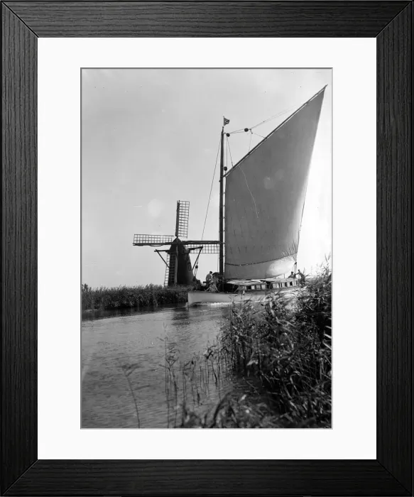 Framed Print : A traditional Norfolk Broad yachts sailing past one of the many windmill water pumps that