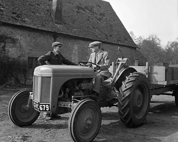 Harry Ferguson The designer of the Ferguson Tractor driving a tractor with trailer
