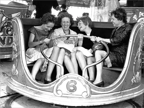 Women enjoying themselves on the Waltzers fair ride. Hearsall Common, Coventry