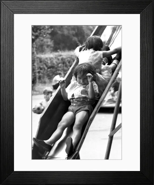 Framed Print : Children play on a slide at the War Memorial Park, Coventry. 28th August 1967 Framed Print : Children play on a slide at the War Memorial Park, Coventry. 28th August 1967